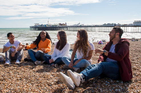 Summer School students laughing on Brighton beach