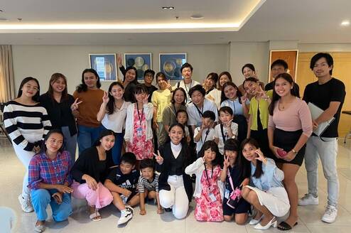 Graduating students posing with their teachers during the ceremony.