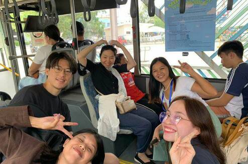 Students and a teacher riding a bus for their Friday practical lesson.