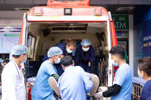 emergency team helping the patient in ambulance 