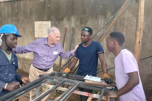 Volunteer supporting vocational training workshop at RMFSL Skilling Station in Kampala