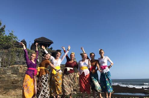 Students in traditional clothes on beach in Indonesia
