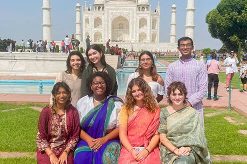 Students pose in front of the Taj Mahal.