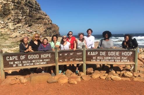 Students pose at Cape of Good Hope sign.