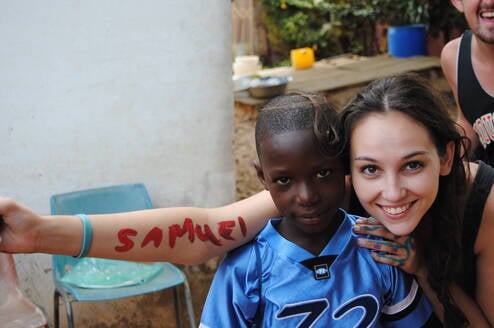 Teacher with students in Ghana