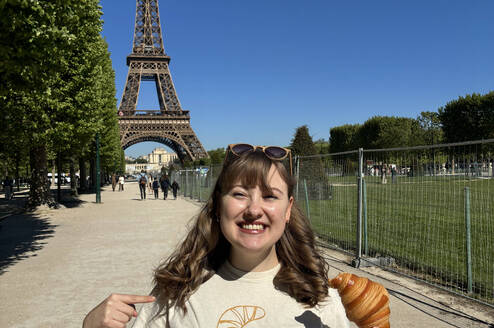 Woman standing beside eiffel tower