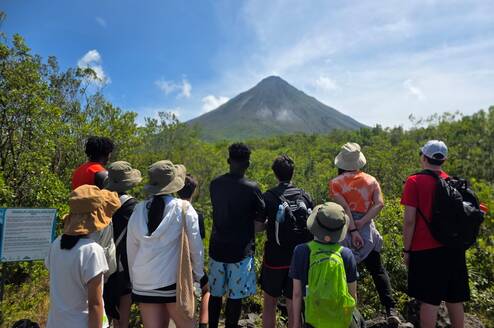 International students observing the Arenal Volcano during a cultural and educational experience in Costa Rica.