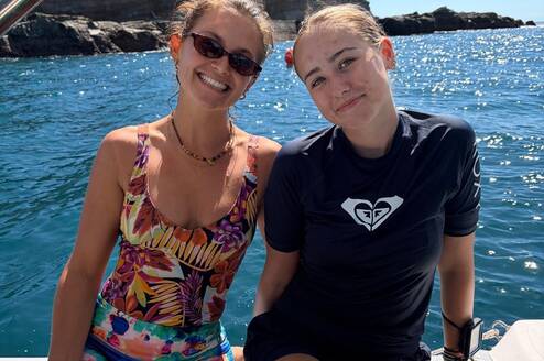 two girls sitting on a boat