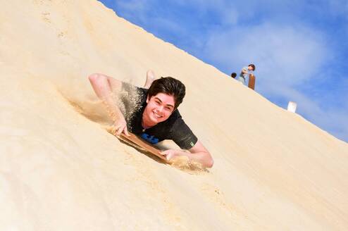 Teen sandboarding in Australia
