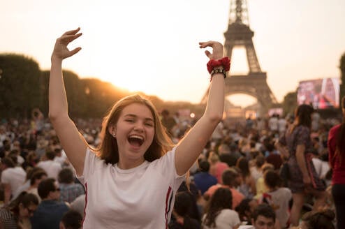 Girl posing with arms up in Paris