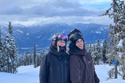 Two people smiling on a snowy mountain