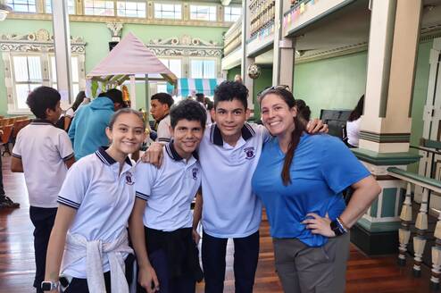 Volunteer helping Costa Rican students practice English through classroom activities and conversation in Heredia.