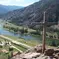 photo of river with a cross in the foreground