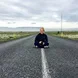 woman sitting in middle of road