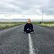 woman sitting in middle of road