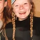 headshot of girl with braids wearing hat