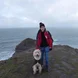 Girl with dog on cliff