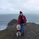 Girl with dog on cliff