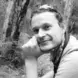 black and white image of man in wooded area