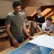 Male teacher showing Cowhouse gap year students prints