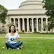 Candy sitting in the grass in front of MIT.