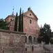 the pink brick facade of a building in the Moorish architectural style