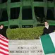 two people posing with Irish and American flags outside of a US Embassy