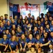 A group of participants posing in matching t-shirts