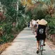 A group of people riding bikes along a road