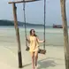 Anna on a swing in the ocean