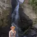 Kasia posing in front of a waterfall