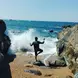 Carlos posing in front of a crashing wave