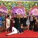 Alexa poses with friends in front of a colorful backdrop