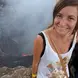 Emily Miller standing at the top of a volcano smiling 