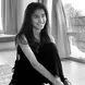 INTAN STEFHANIE wearing a black jumpsuit with long dark hair and smiling