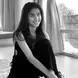 INTAN STEFHANIE wearing a black jumpsuit with long dark hair and smiling