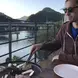 SJ Vermaak grilling food wearing sunglasses on a dock by a river
