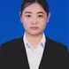 Tang with a white button up shirt, black blazer, and dark hair tied in a bun