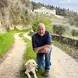 Lorenzo smiles happily beside his dog in the countryside