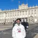 Jack stands in front of a beautiful European style building for a photo