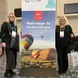 image of two women standing in front of an educational poster