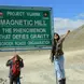 woman by the magnetic hill sign project vijayak