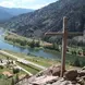 photo of river with a cross in the foreground
