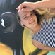 Photo of Mary in front of a mural