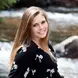 Image of Brooke sitting by a river