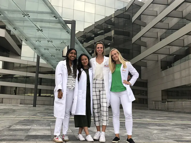 4 people wearing white coats