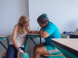 Teaching intern assisting child 