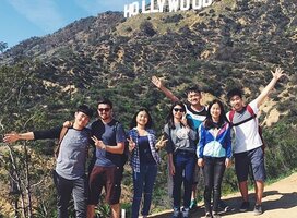 People posing in front of Hollywood sign
