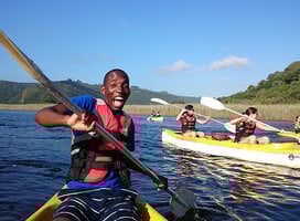 Male student on a kayak living his best life in Cape Town 