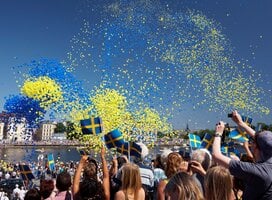 swedish festival with balloons in the air and people celebrating